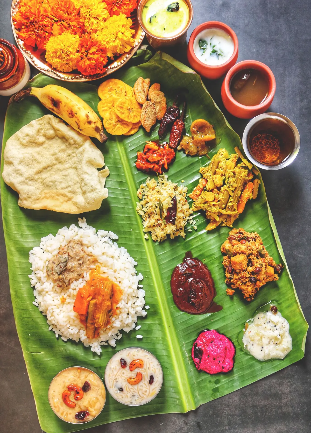 A traditional Indian feast with rice, curries, and accompaniments served on a banana leaf